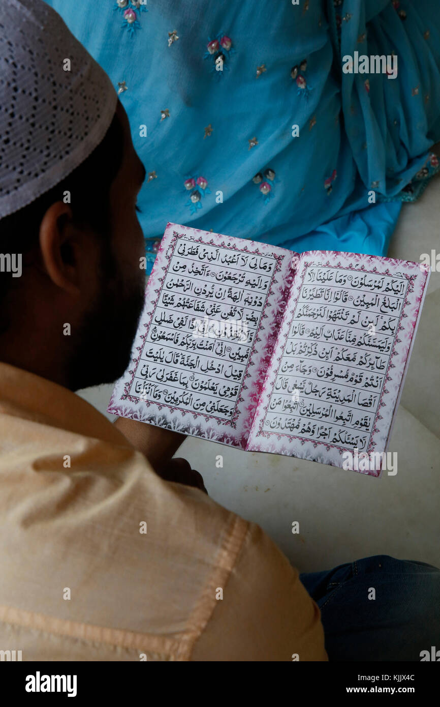 Faithful reading in Nizamuddin dergah, Delhi, India. Stock Photo