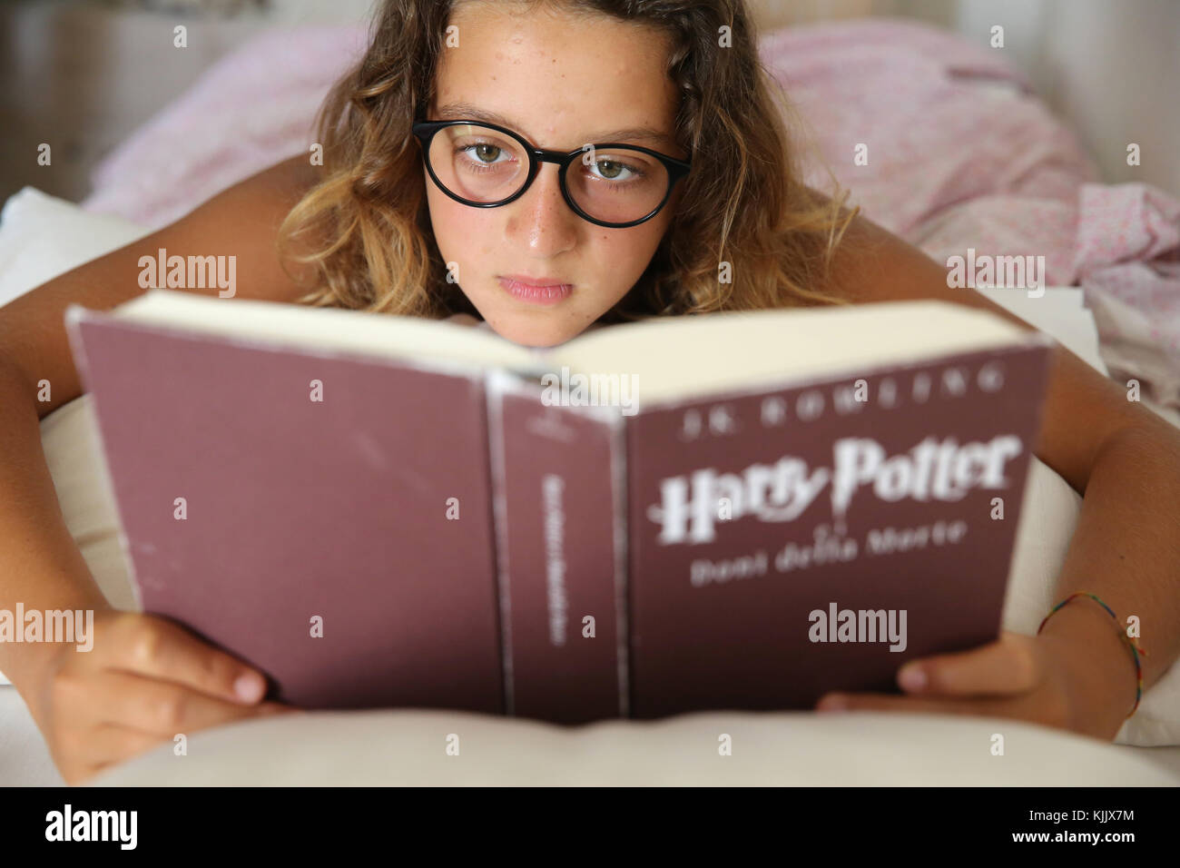 Girl reading Harry Potter. Stock Photo