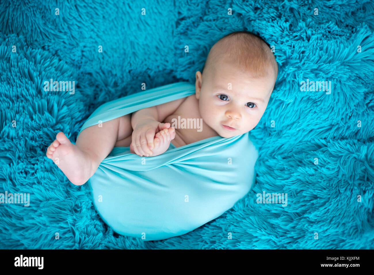 Cute Three Months Old Baby Boy In Blue Wrap Lying On A Blue Blanket Stock Photo Alamy