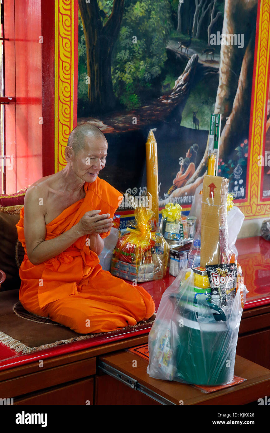 Monk receiving gifts for Khao Pansa in Wat Dab Phai temple, Chiang Mai. Thailand. Stock Photo