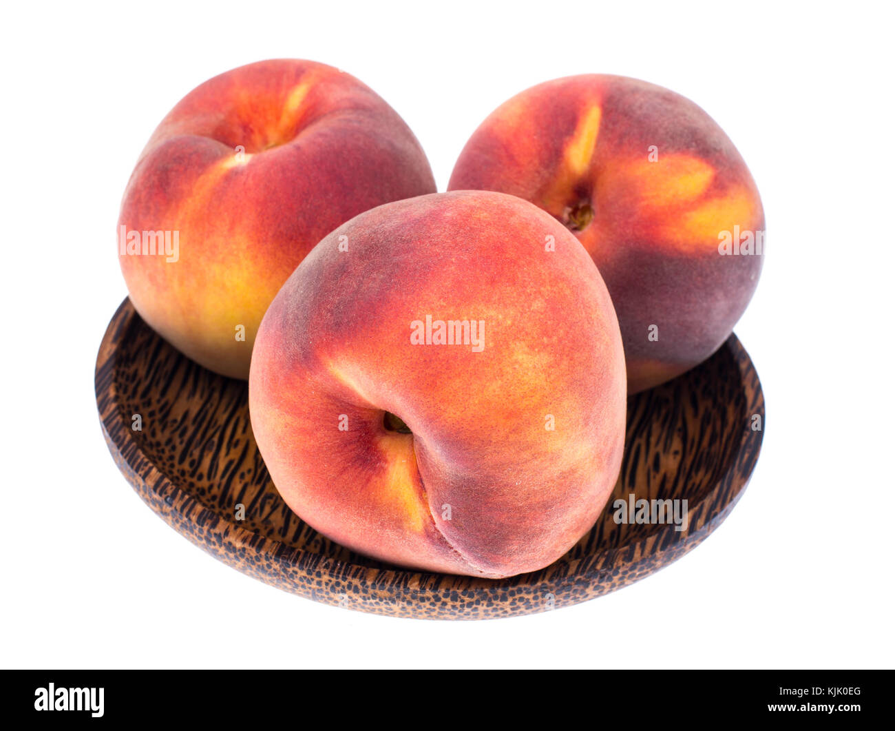 Delicious whole ripe peaches on wooden plate. Studio Photo Stock Photo ...