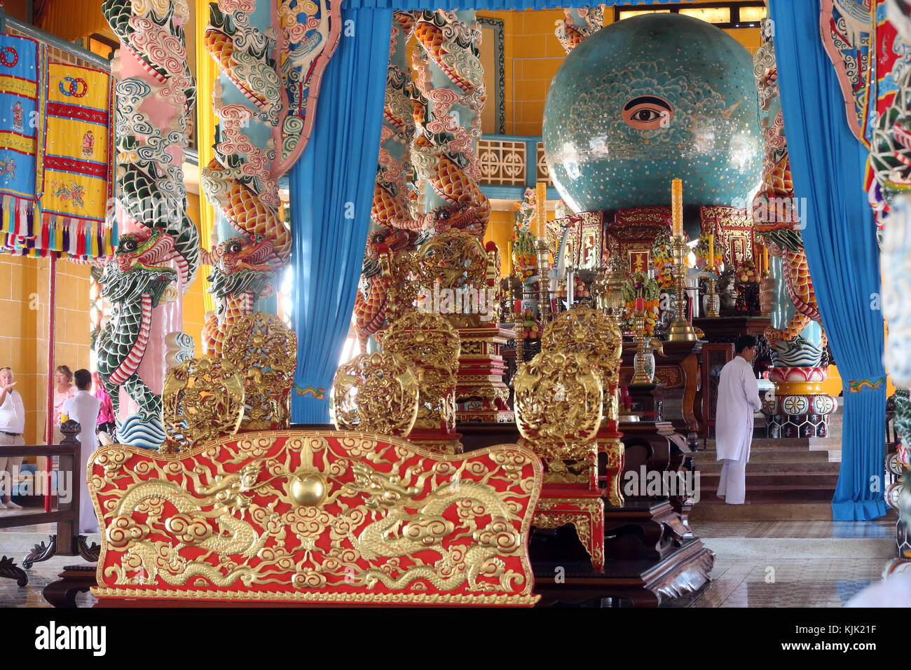 Interior of Cao Dai Great Temple with Divine Eye and dragon pillars surrounding it.  Thay Ninh. Vietnam. Stock Photo