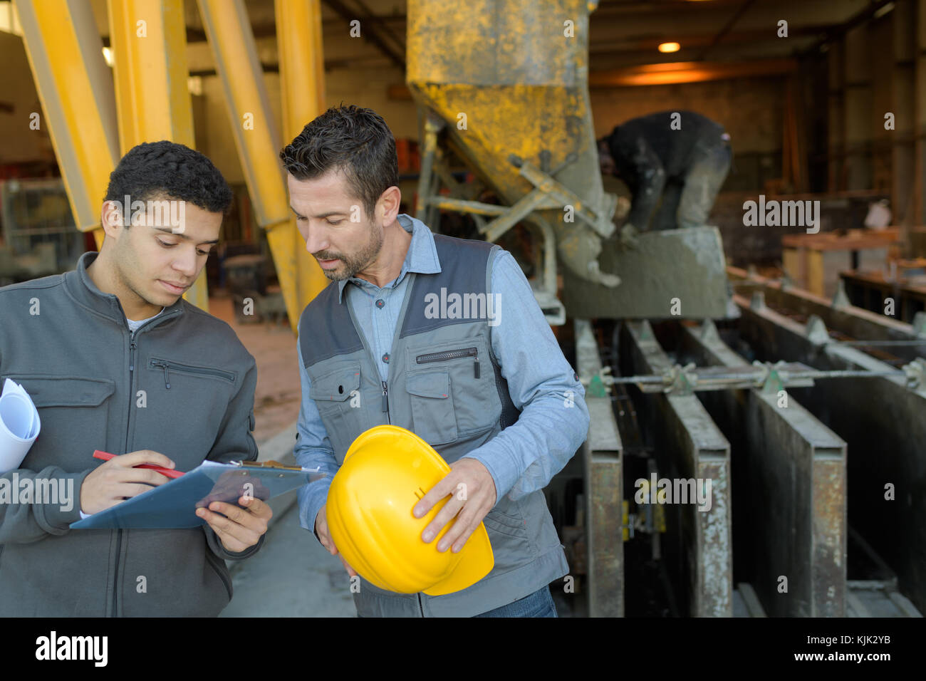 2 workers discussing in metalworks factory Stock Photo