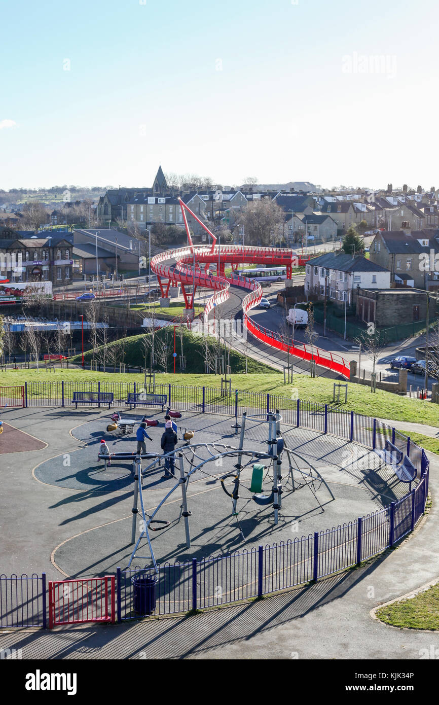 Big red bridge on Manchester rd, Bradford, West Yorkshire, pedestrian and cycle bridge in a deconstructive style. Steel built construction. Playground Stock Photo
