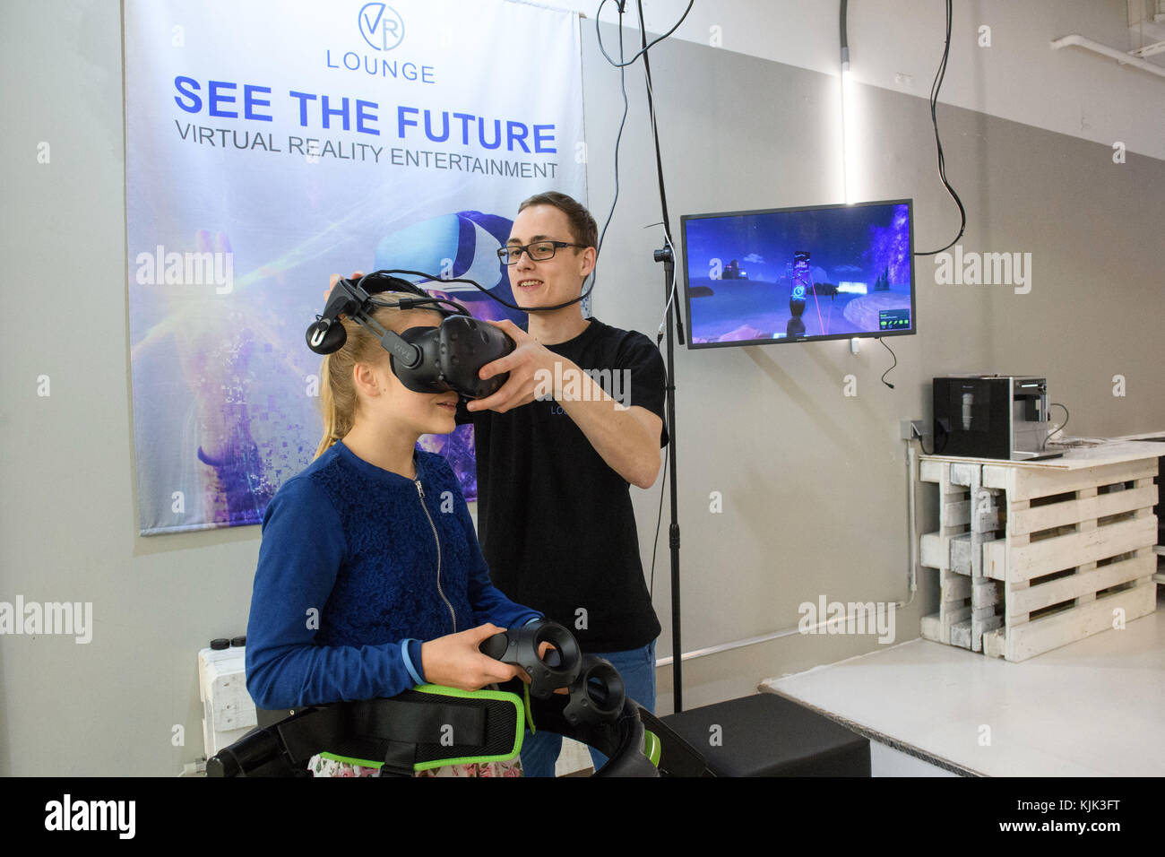 An employee of the VR Lounge at Potsdamer Platz in Berlin helps a