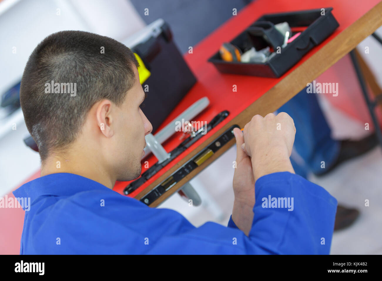 Contractor fitting door locking mechanism Stock Photo - Alamy