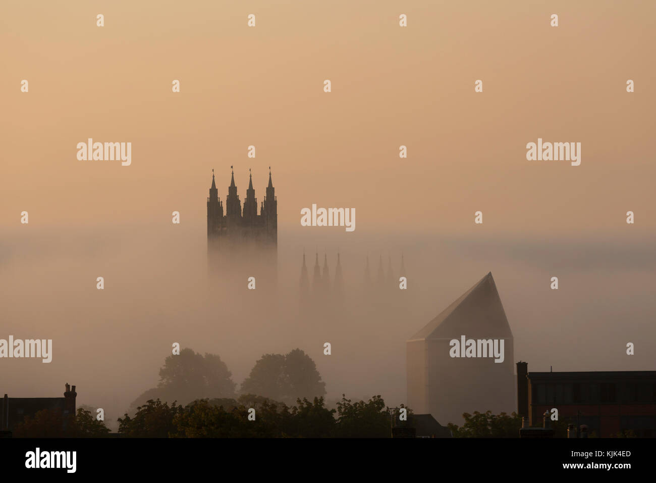 Canterbury Cathedral and the Marlowe Theatre in a misty dawn, Canterbury, Kent, UK. Stock Photo