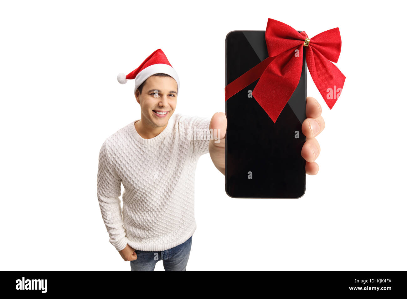 Young man with a santa hat showing a phone wrapped with red ribbon as a gift isolated on white background Stock Photo