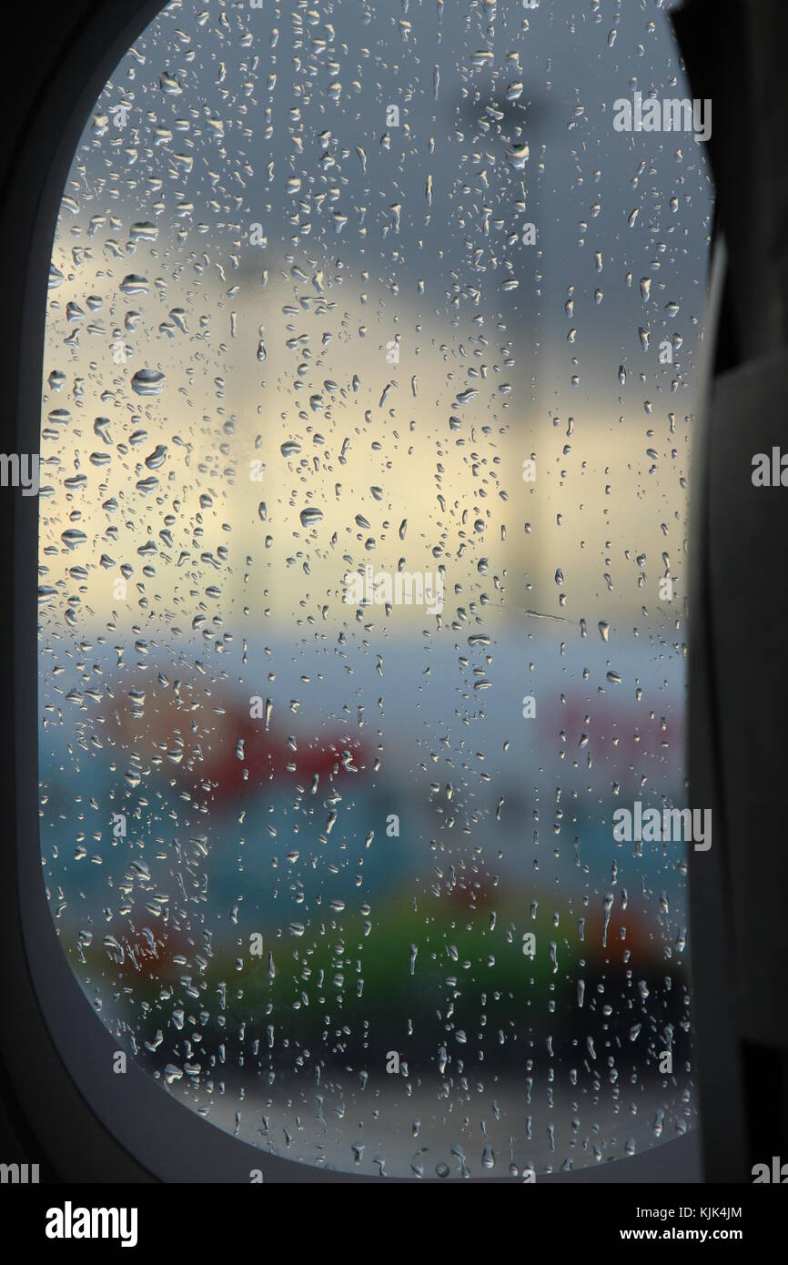 Airplane Window with raindrops Stock Photo