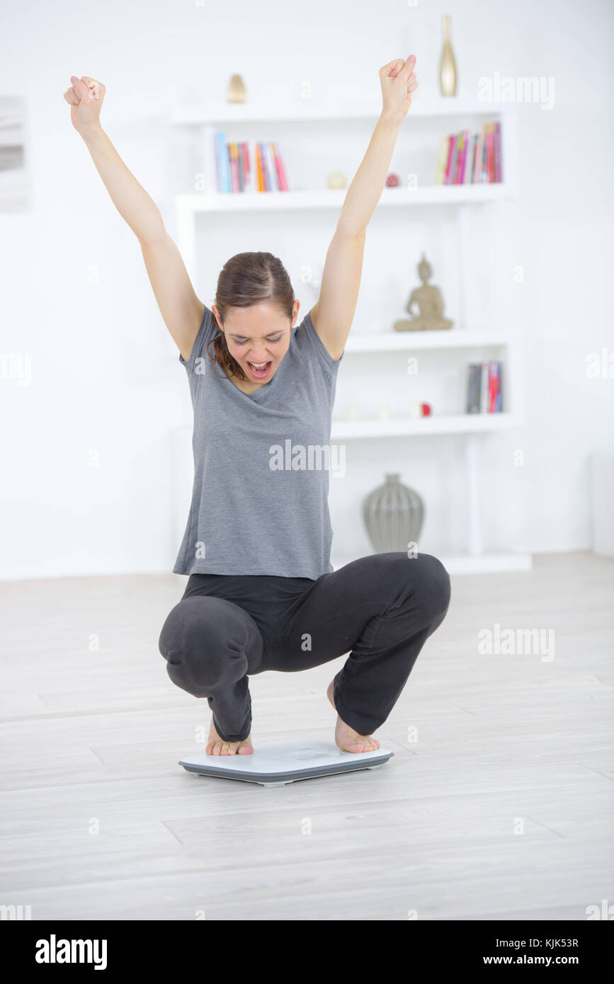 beautiful woman happy after measuring her weight Stock Photo - Alamy