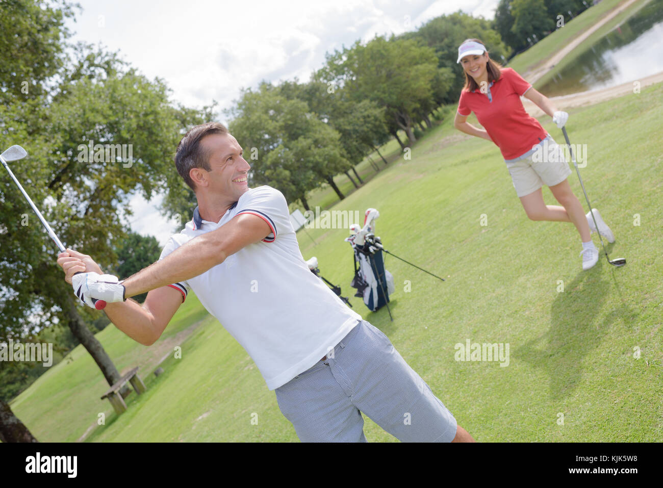 male golf instructor teaching female golf player Stock Photo Alamy