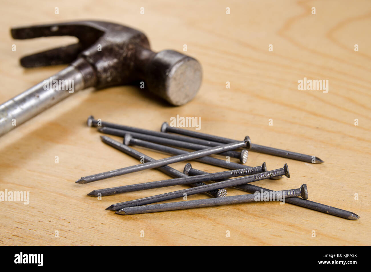 Hammer and nails in the background of plywood Stock Photo