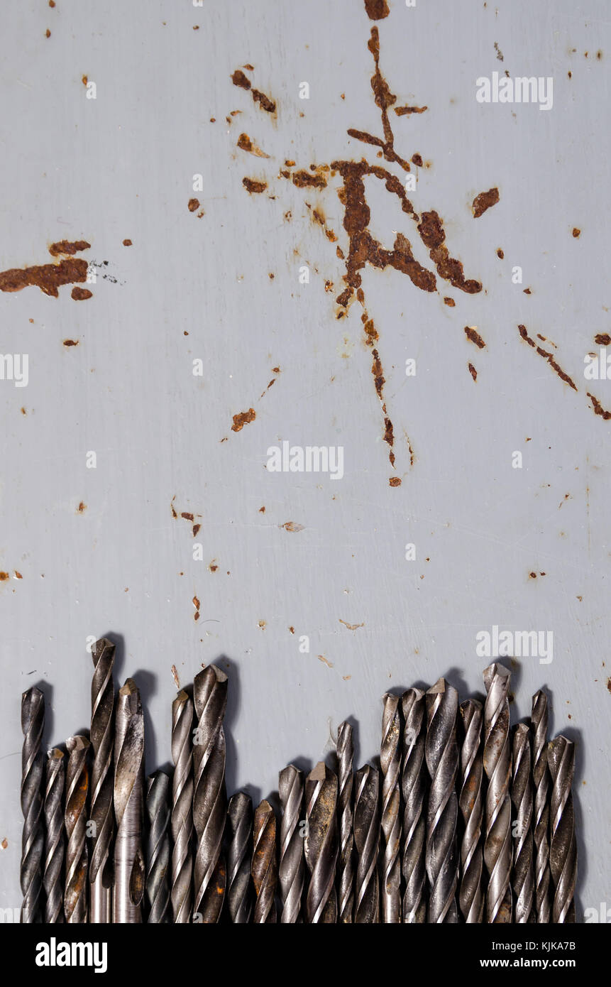 a lot of drills of different sizes on a painted metal background.vertical view. Stock Photo