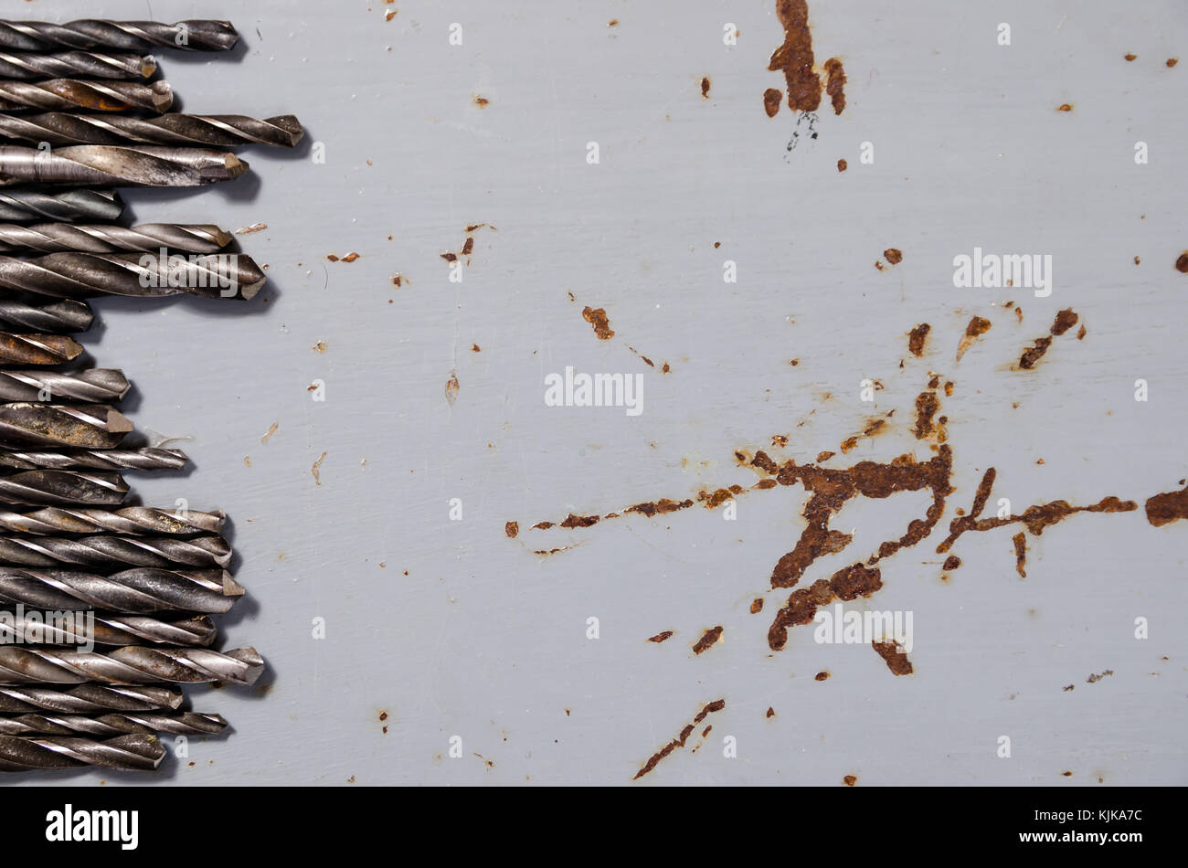 a lot of drills of different sizes on a painted metal background Stock Photo