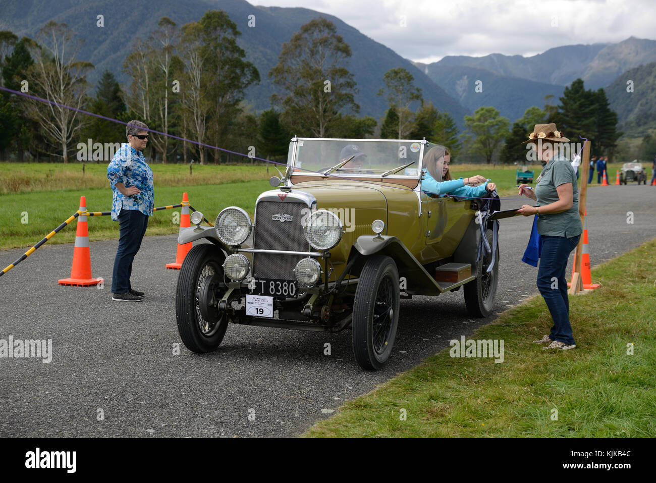 HAUPIRI, NEW ZEALAND, MARCH 18, 2017: Contestants in a vintage car rally hang out washing in a timed competition. The vehicle is a 1930 Alvis Silver S Stock Photo