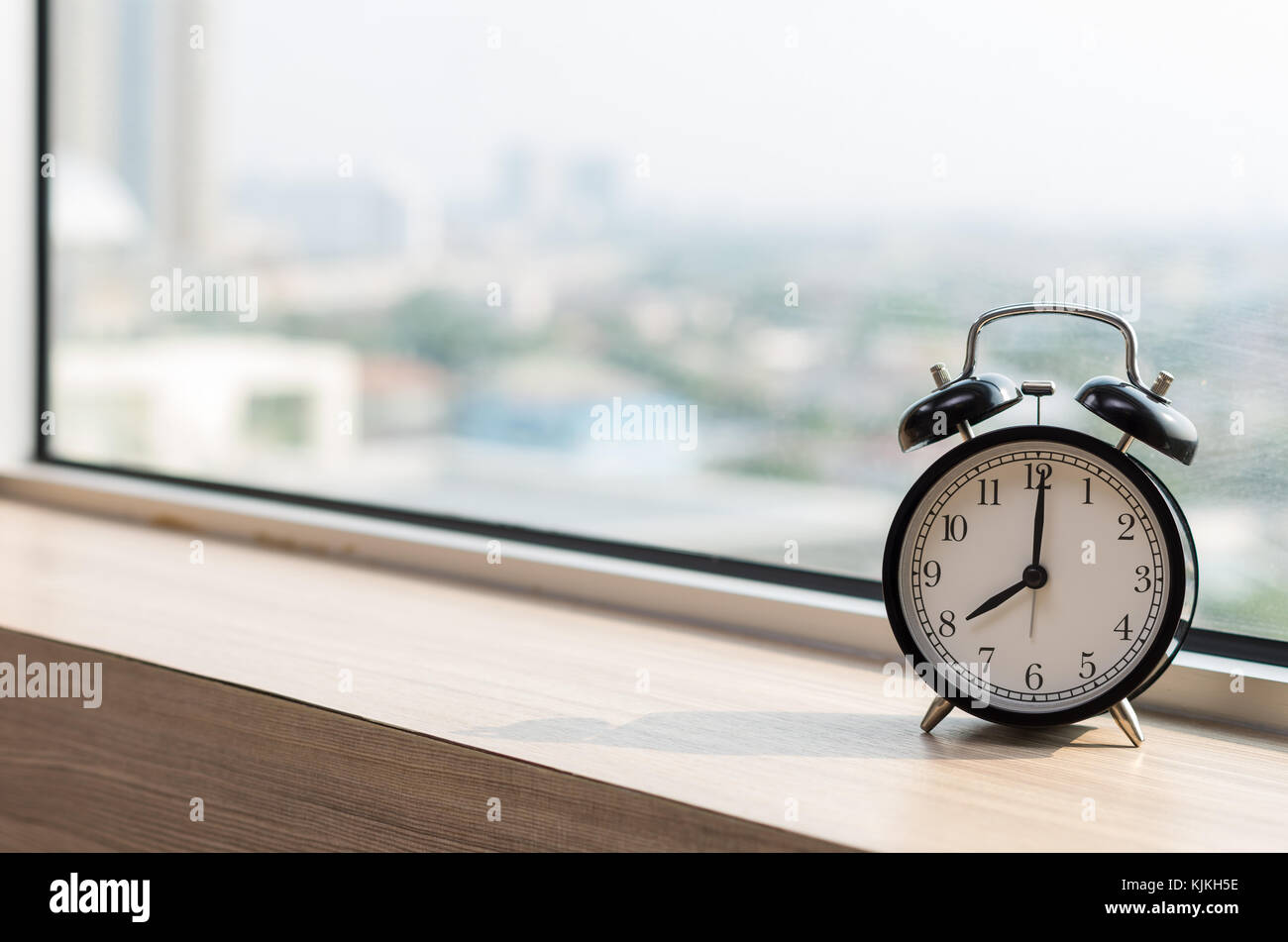 Vintage alarm clock at windows at early morning Stock Photo - Alamy