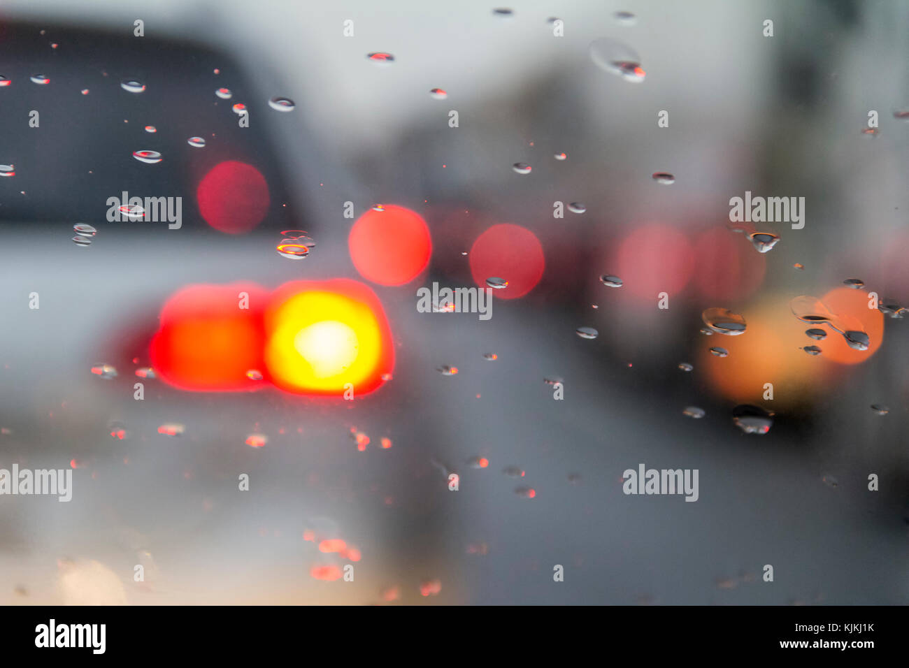 blurry dusky road scenery and water drops on front window on a highway in Germany at autumn time Stock Photo