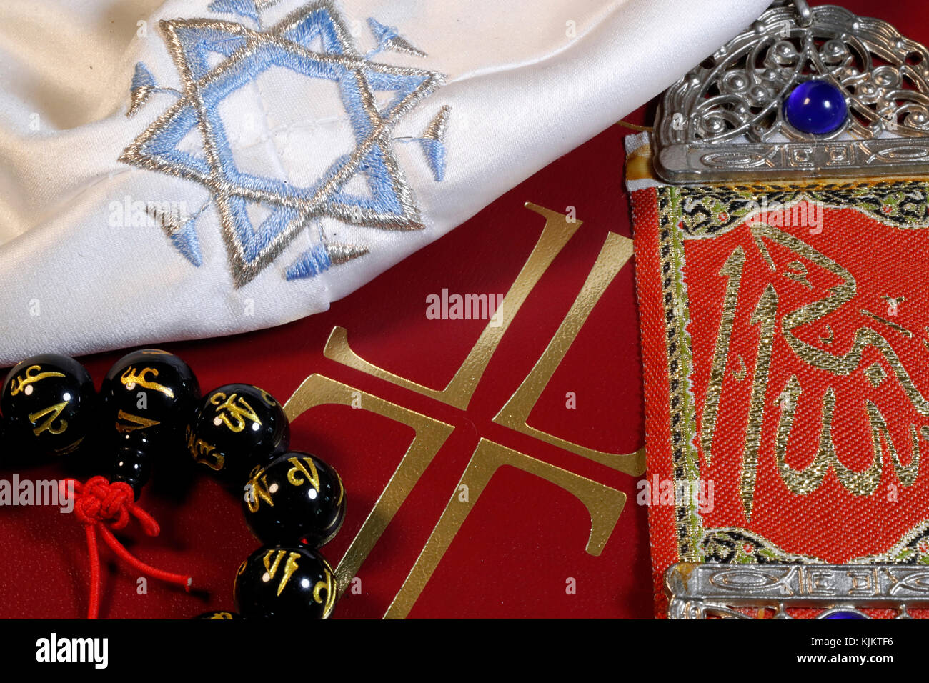 Christianity, buddhism,  Islam and Judaism. Interfaith symbols : bible, Kippah, Allah monogram  and mala. Stock Photo