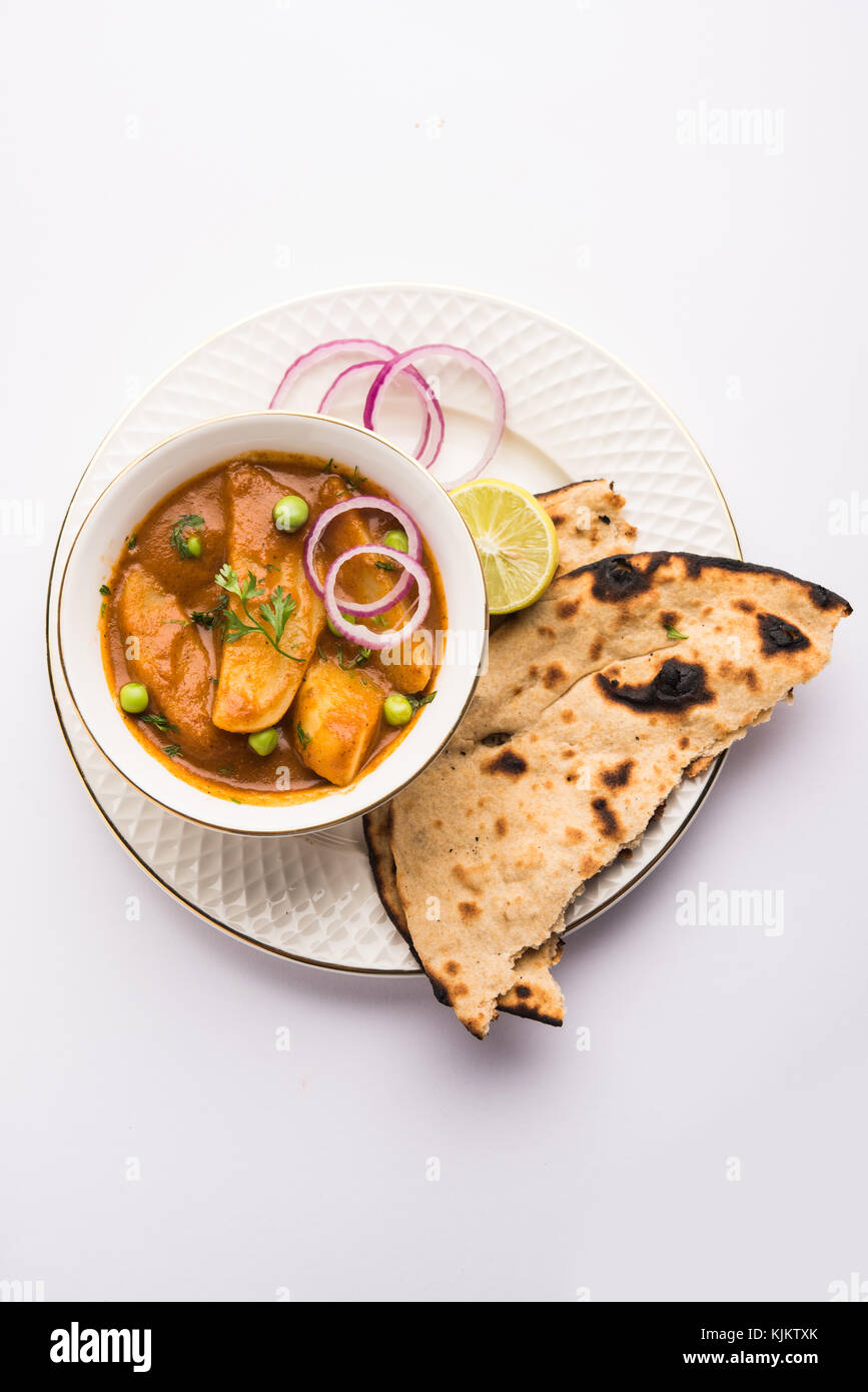 potato curry or aloo masala or alu masala with green peas, served with