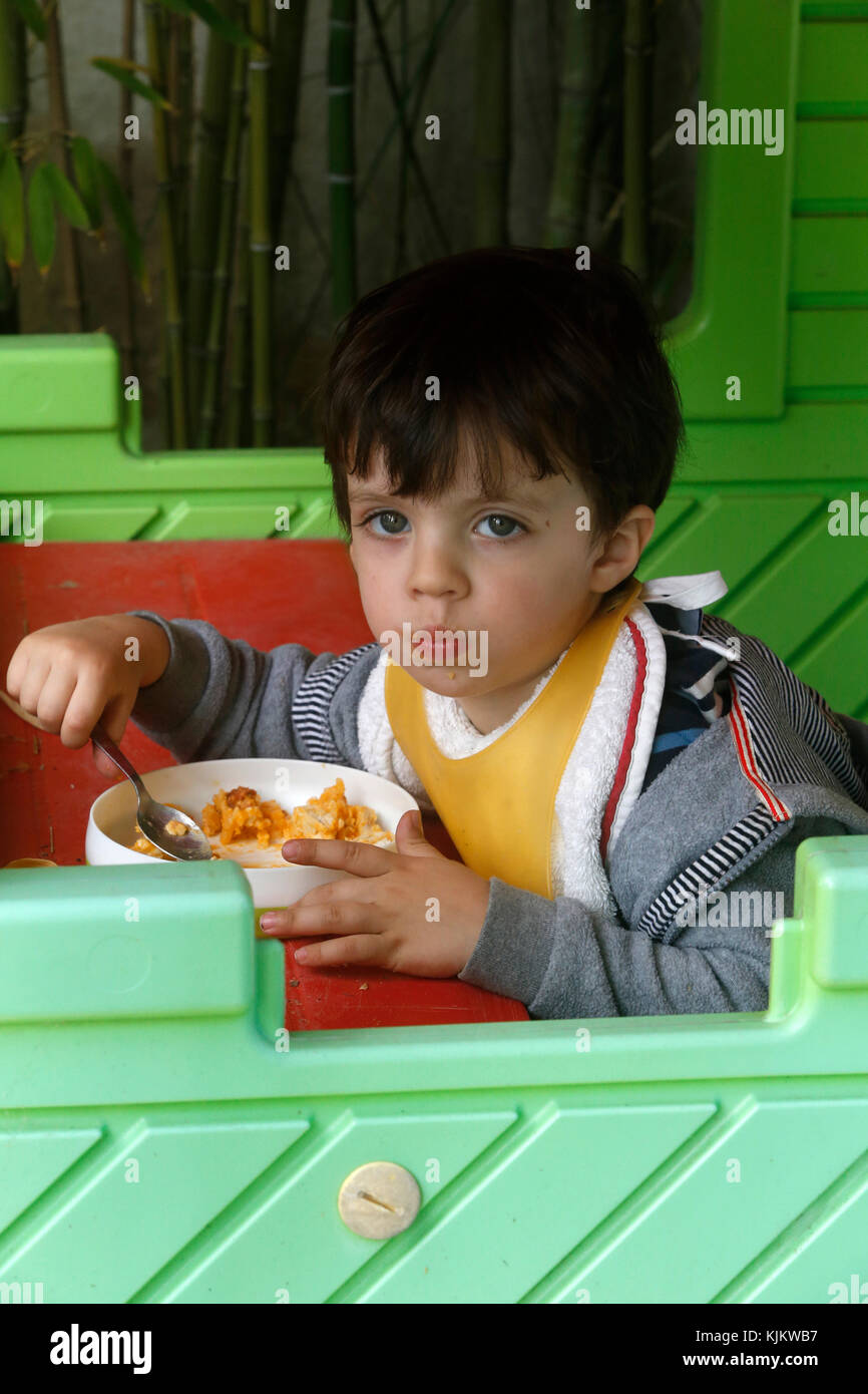 2-year-old boy eating in a kid's house. Marseilles. France. Stock Photo