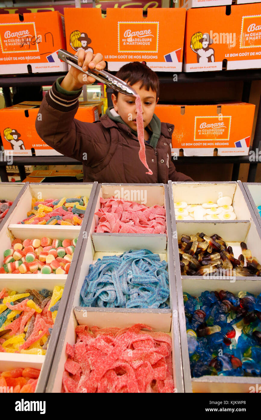 10-year-old boy buying candies. France. Stock Photo