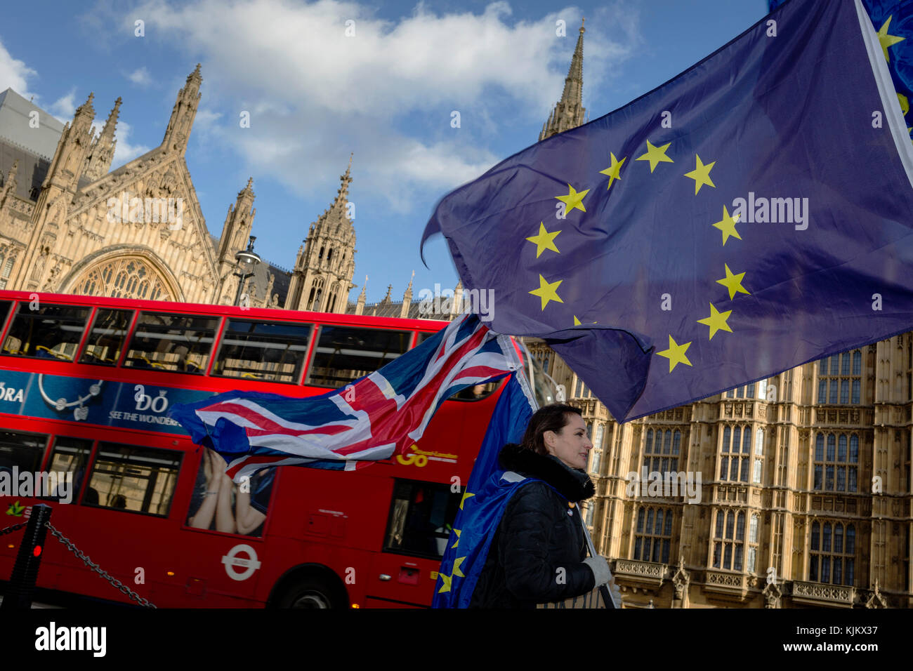 The stars of the EU flag fly over a London bus and the Houses of Parliament in Westminster, seat of government and power of the United Kingdom during Brexit negotiations with Brussels, on 23rd November 2017, in London England. Stock Photo