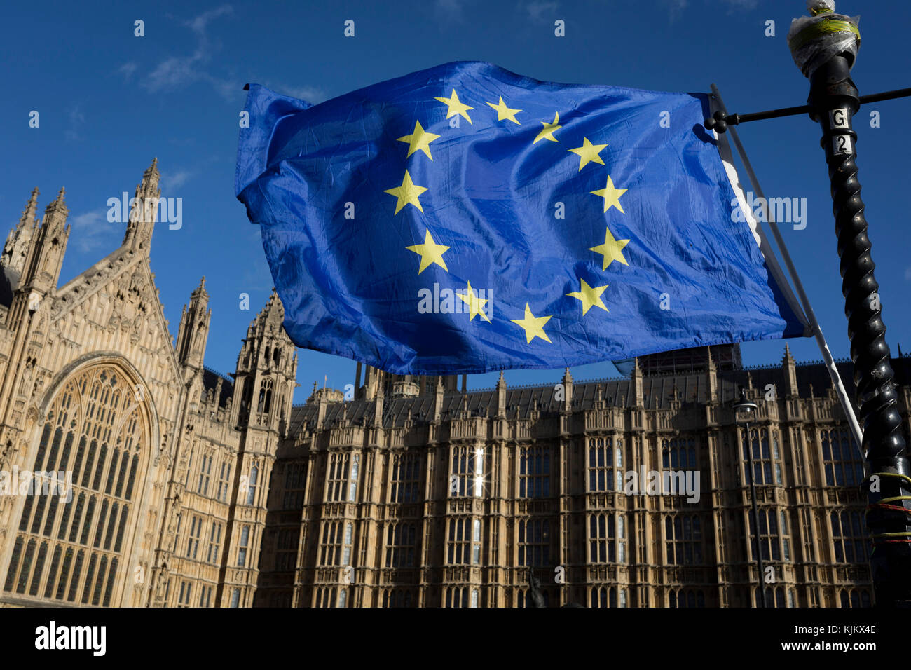 The stars of the EU flag fly over the Houses of Parliament in Westminster, seat of government and power of the United Kingdom during Brexit negotiations with Brussels, on 23rd November 2017, in London England. Stock Photo