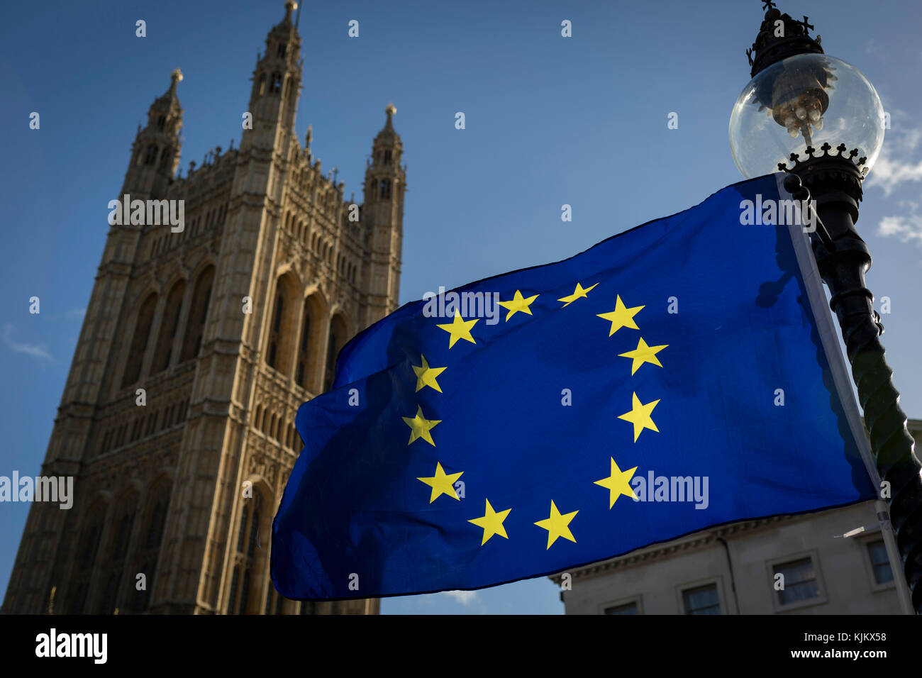 The stars of the EU flag fly over the Victoria Tower at the  Houses of Parliament in Westminster, seat of government and power of the United Kingdom during Brexit negotiations with Brussels, on 23rd November 2017, in London England. Stock Photo