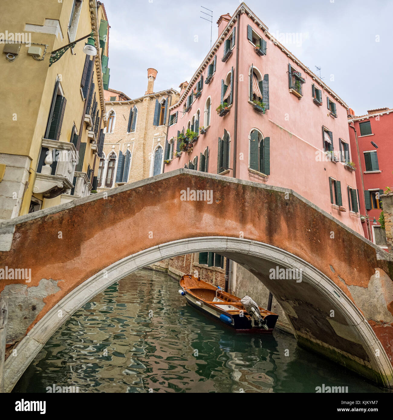 VENICE, ITALY - SEPTEMBER 12, 2017:  Bridge over canal seen against brightly coloured buildings Stock Photo
