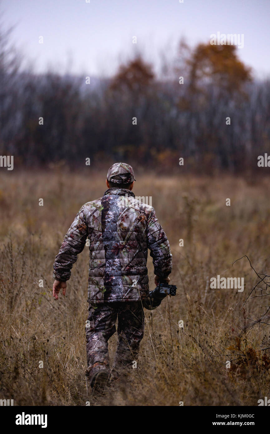 professional photographer with camouflage outfit in nature Stock Photo ...