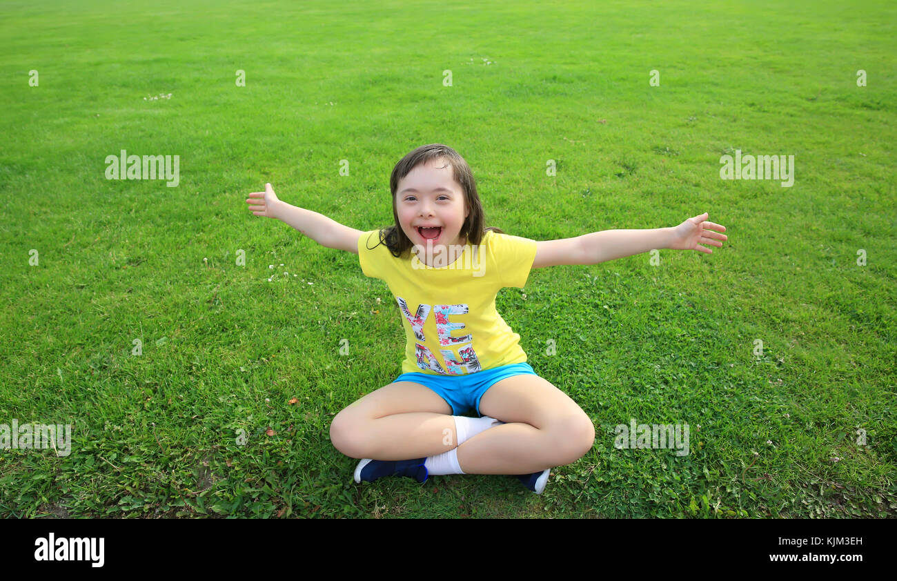 Young girl on the background of green grass Stock Photo - Alamy
