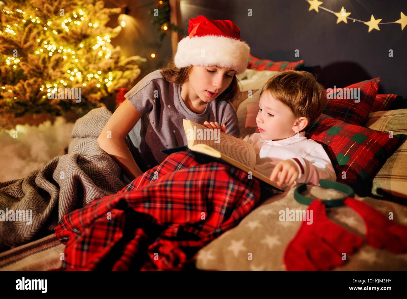 A children is reading a book in the Christmas room Stock Photo