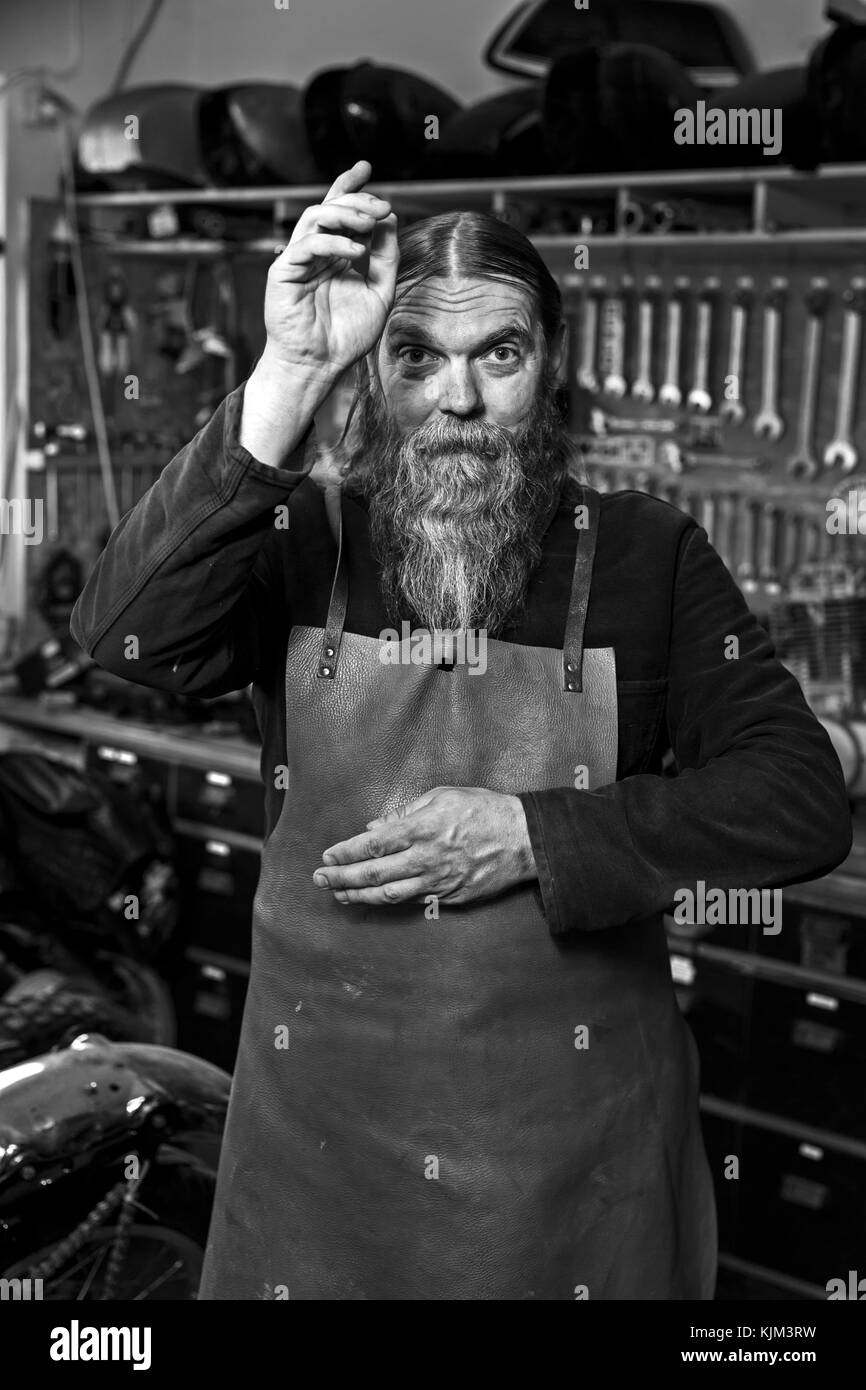 motorcycle freak in his workshop Stock Photo