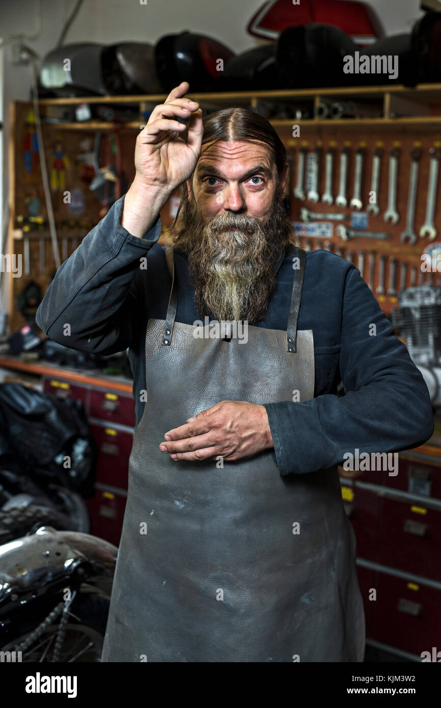 motorcycle freak in his workshop Stock Photo