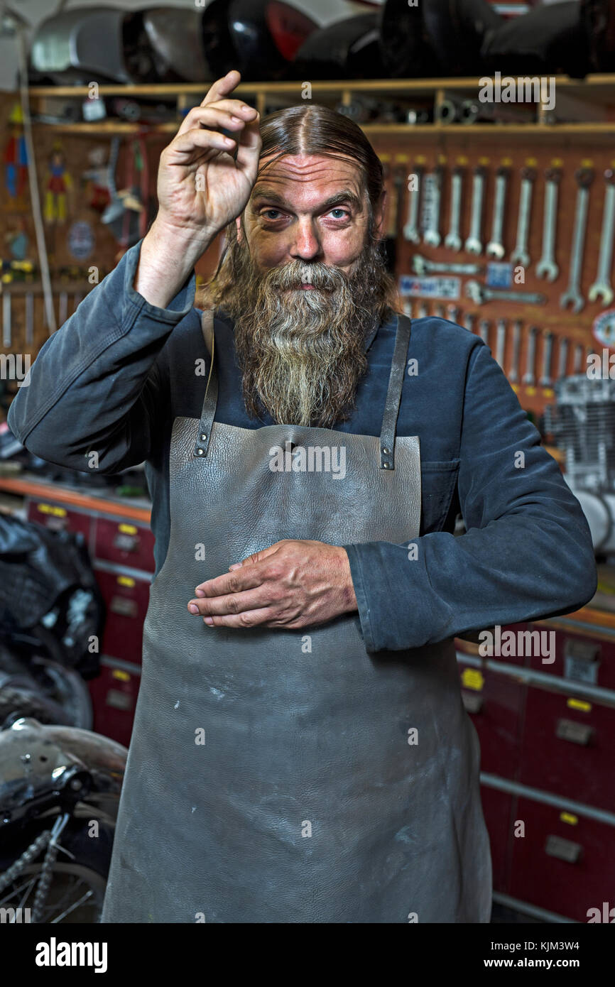 motorcycle freak in his workshop Stock Photo