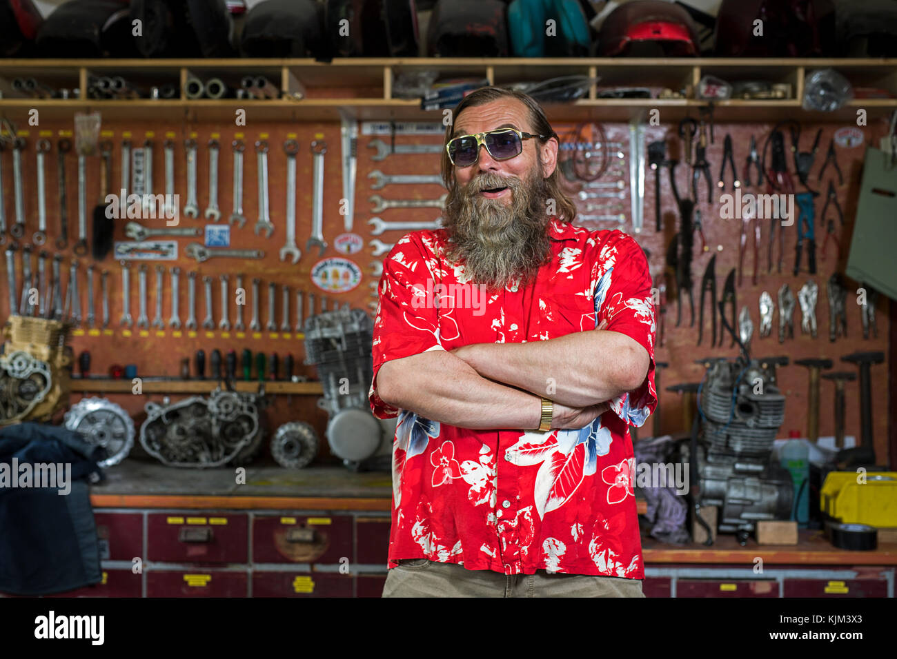 motorcycle freak in his workshop Stock Photo