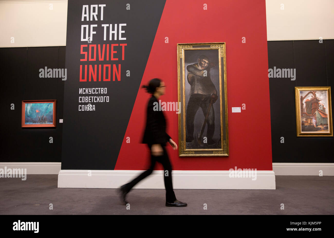 A member of staff walks past 'The Coal Miner' by Alexander Deineka, 1925, (est. £3.5-4.5m) which forms part of Sotheby's Inaugural Sale of Art from the USSR in London to coincide with the 100th Anniversary of the 1917 Russian Revolution. Stock Photo
