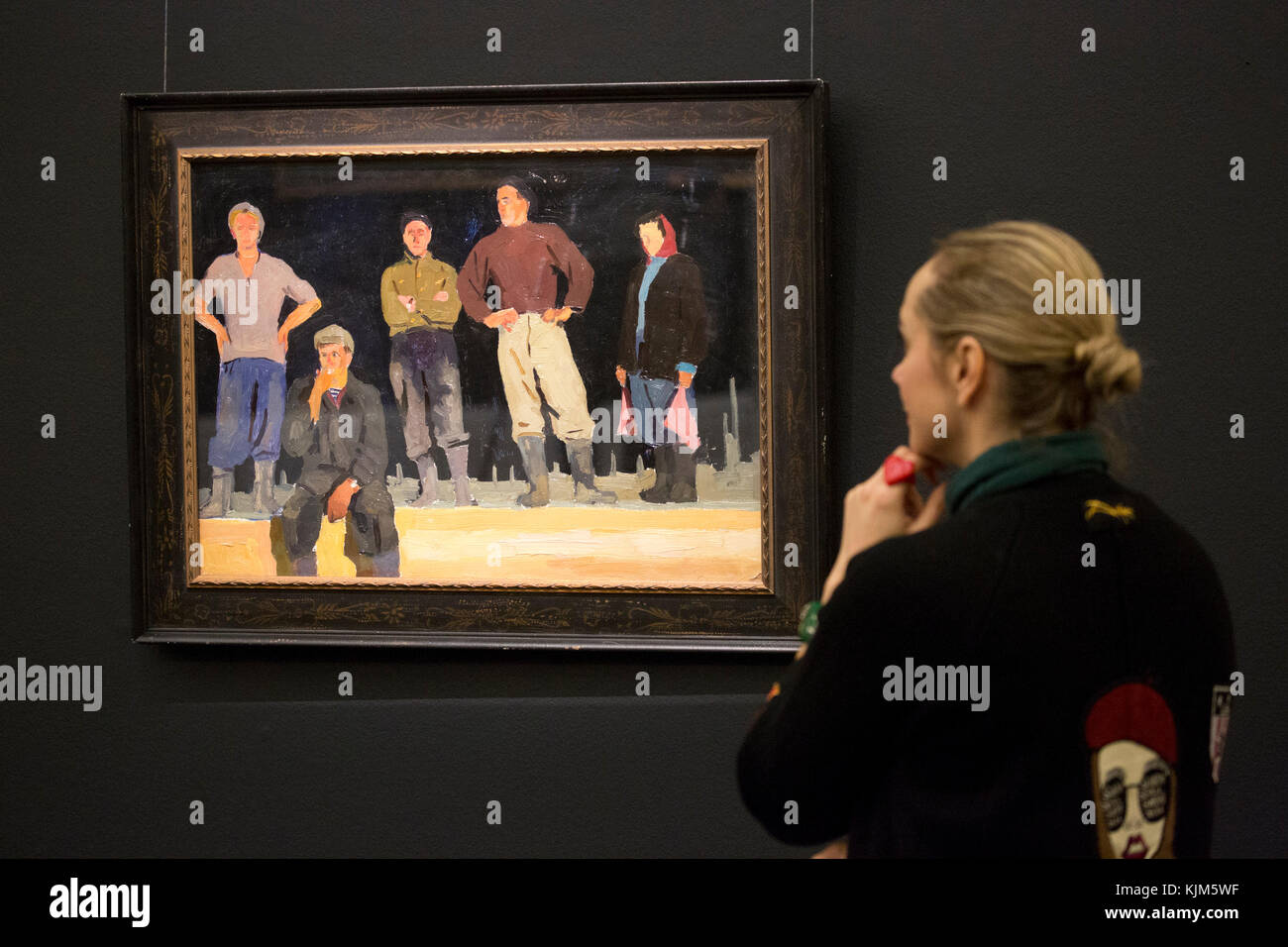 A visitor looks at 'Study for Builders of Bratsk' by Viktor Popkov, 1950s, (est. £8,000-12,000) which forms part of Sotheby's Inaugural Sale of Art from the USSR in London to coincide with the 100th Anniversary of the 1917 Russian Revolution. Stock Photo