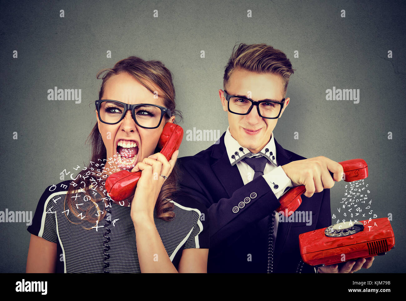 Angry young couple having unpleasant telephone conversation, woman screaming at man Stock Photo