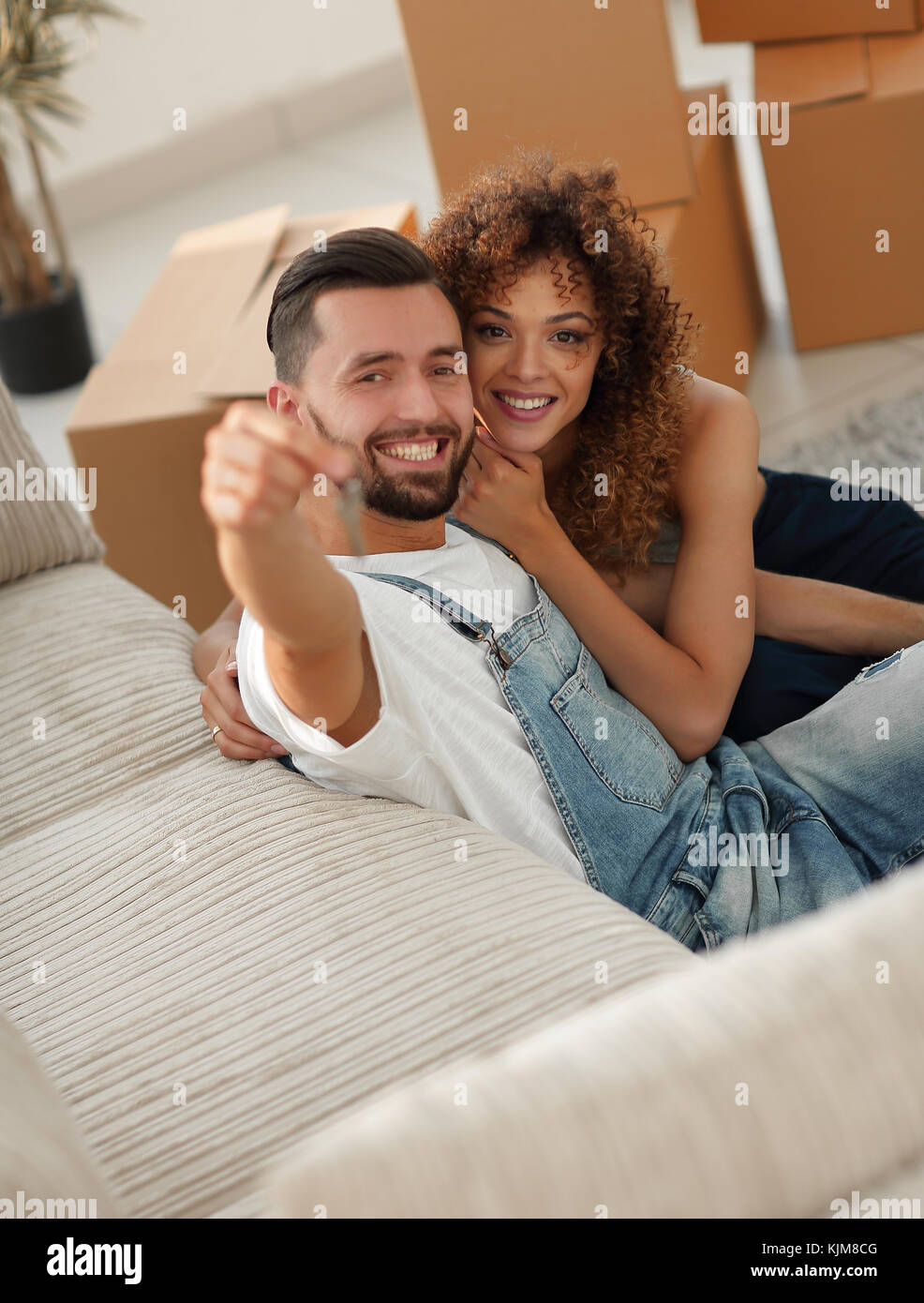 young couple holding the key to a new apartment Stock Photo - Alamy