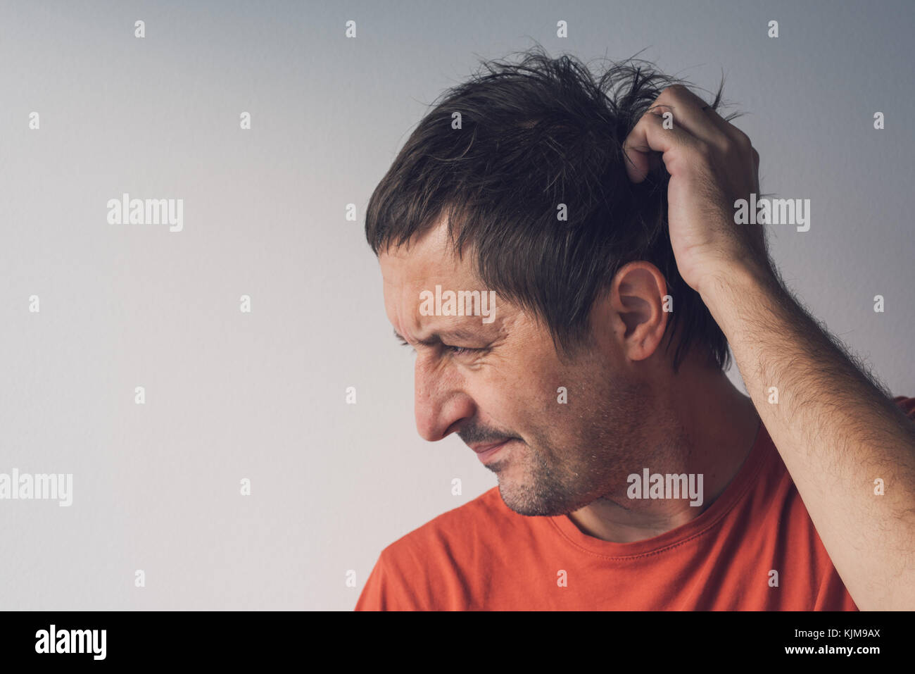 Forgetful absent-minded man is trying to remember something  that he managed to forget. Stock Photo