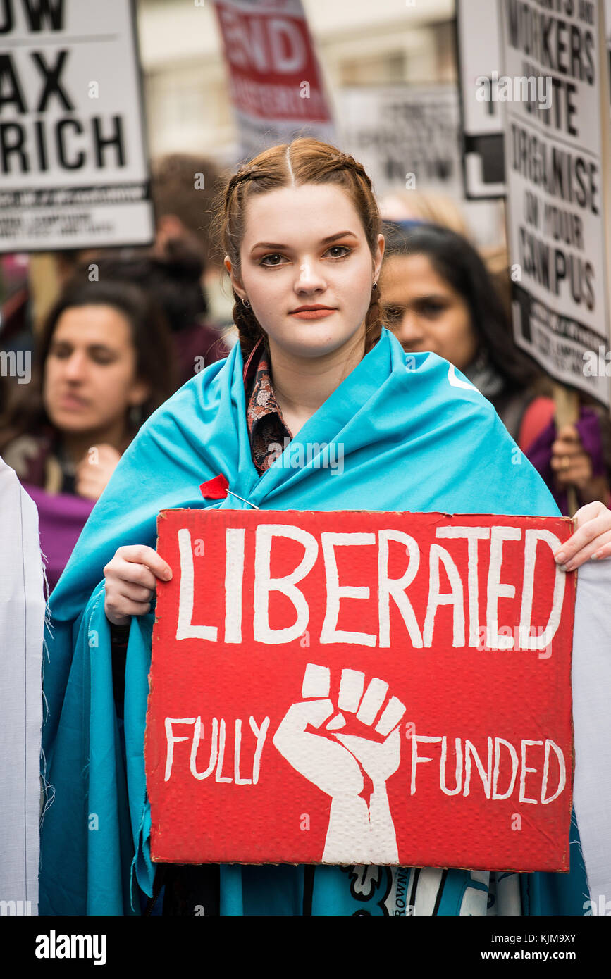 Student with large LIBERATED poster at the protest demo for the Campaign Against Education Fees and Cuts, through the streets of central London, UK. Stock Photo