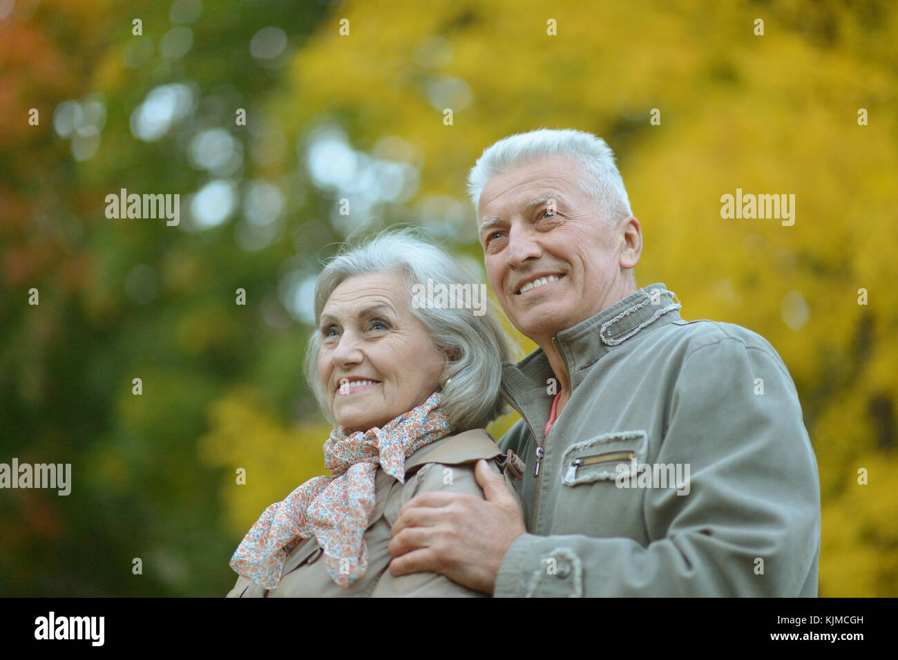 senior couple hugging in the park Stock Photo - Alamy