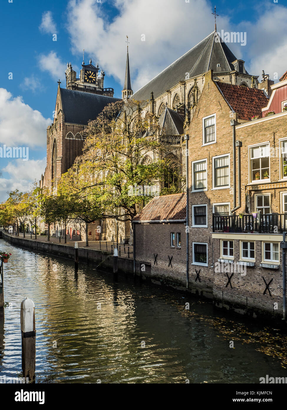 The Grote Kerk in Dordrecht is located next to the Voorstraatshaven, a canal through the historic city center. Stock Photo
