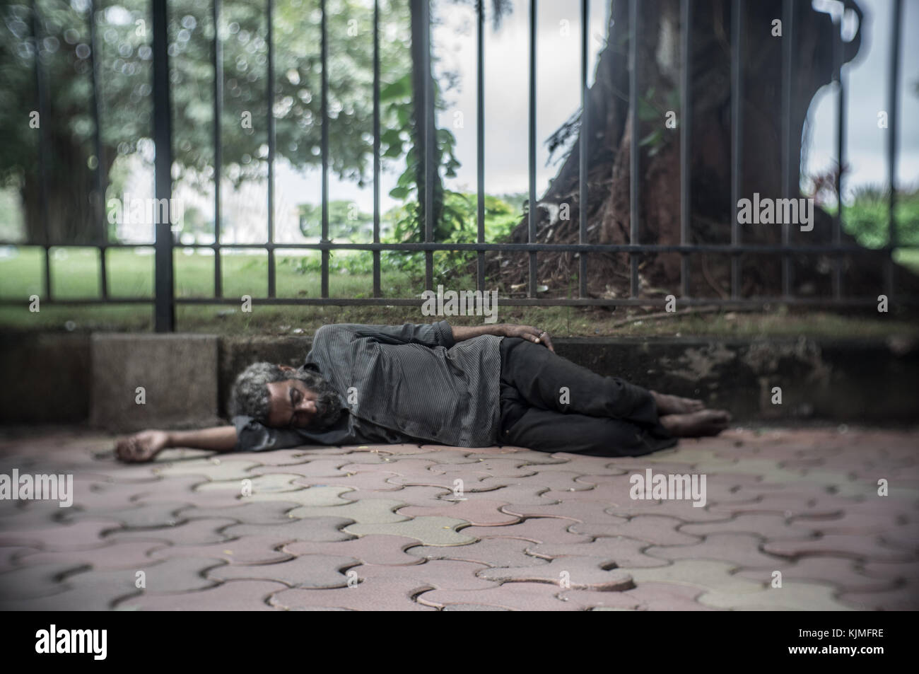 Old homeless man sleeping in the streets om Mumbai, India. Stock Photo