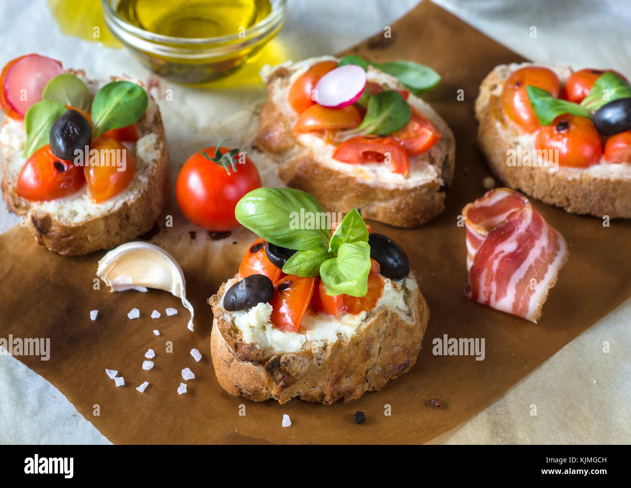 Baked fresh Italian bruschettas with cream cheese and cherry tomato,selective focus Stock Photo