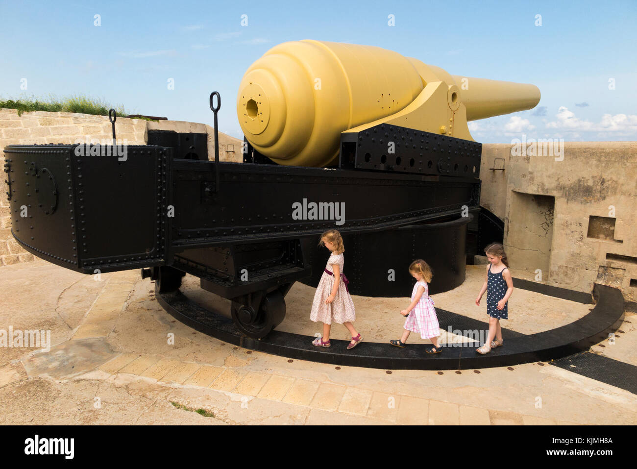 100 Ton gun & kid / kids / child / children, Fort Rinella, Malta. Muzzle loading gun is largest front loading cannon / artillery battery in the world Stock Photo