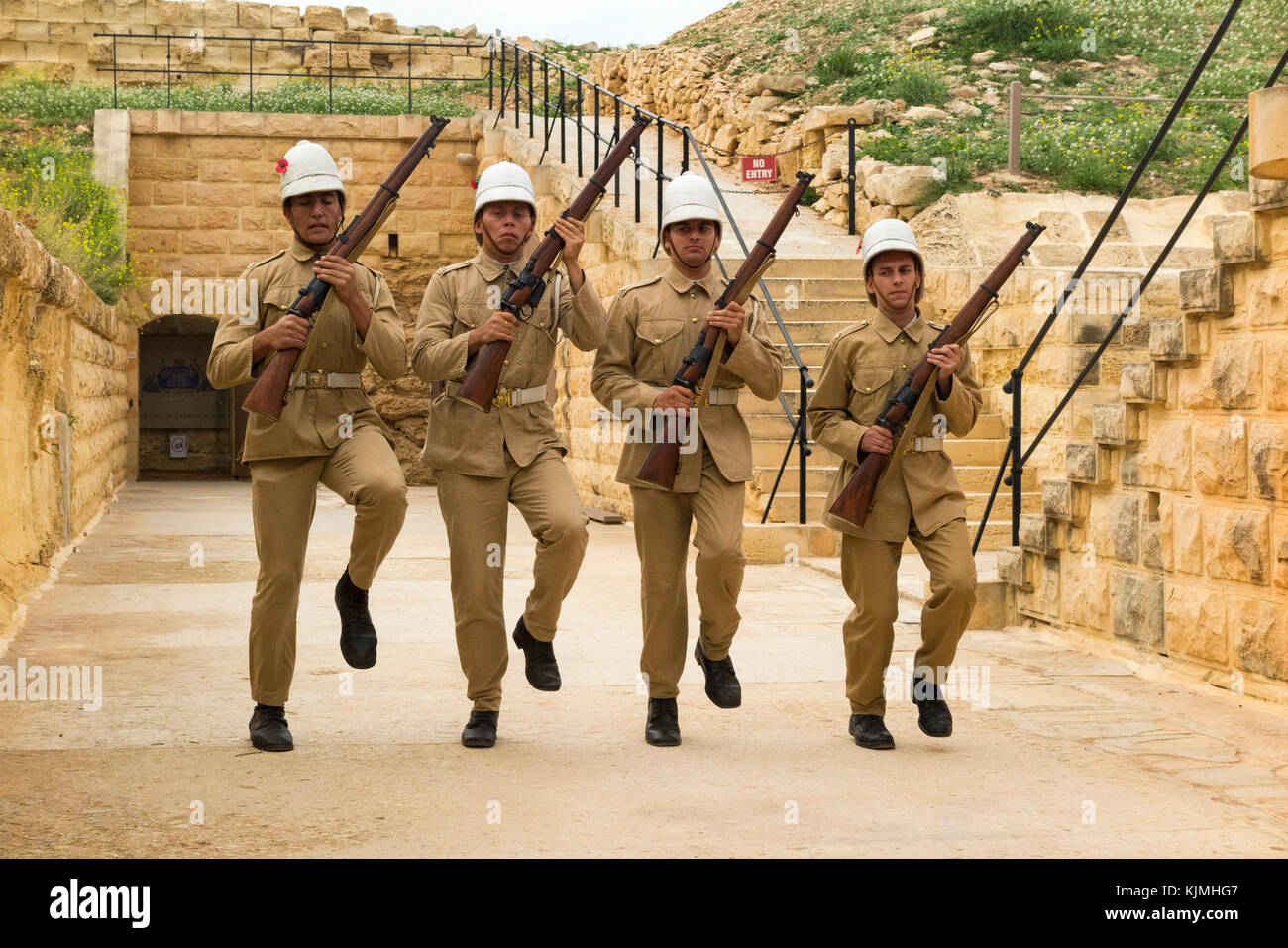 Demonstration drill & dry firing of vintage military musket and rifles – exhibition for tourists visiting Rinella Battery, Fort Rinella, Kalkara, Malta Stock Photo