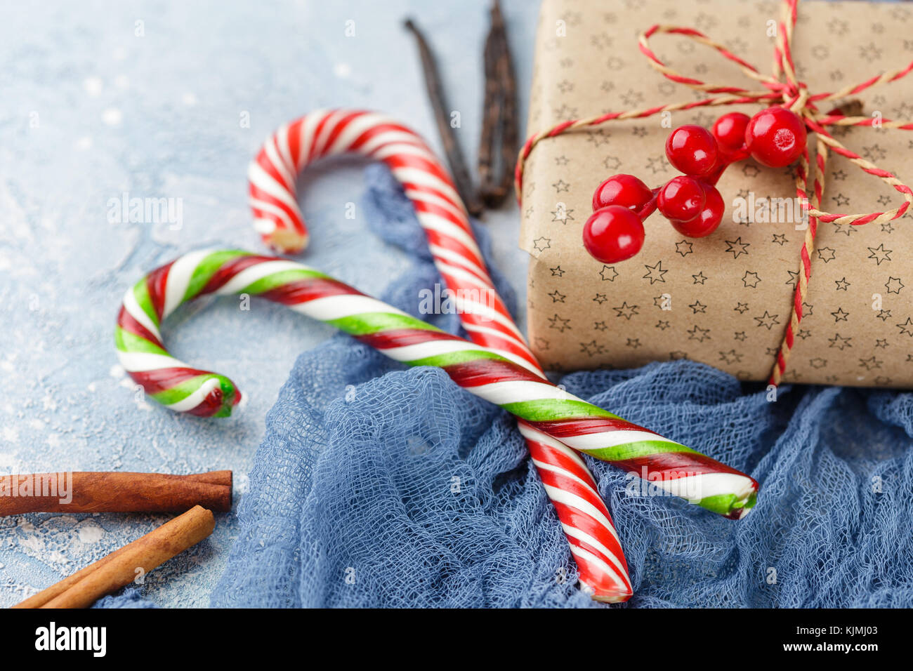 Fresh mandarins with leaves, candy canes, gift boxes in kraft paper and ...