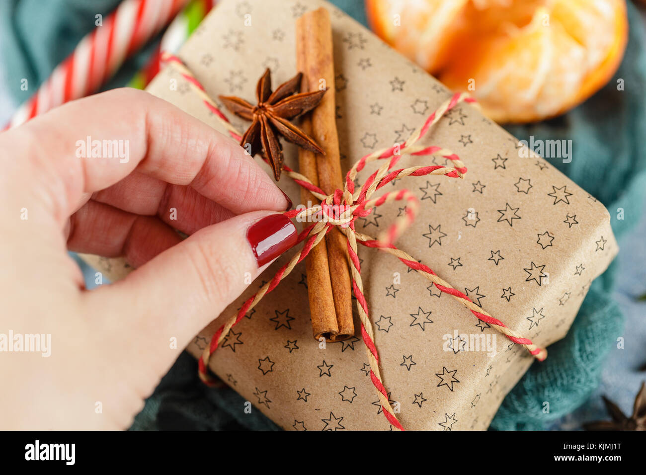 Fresh mandarins with leaves, candy canes, gift boxes in kraft paper and ...